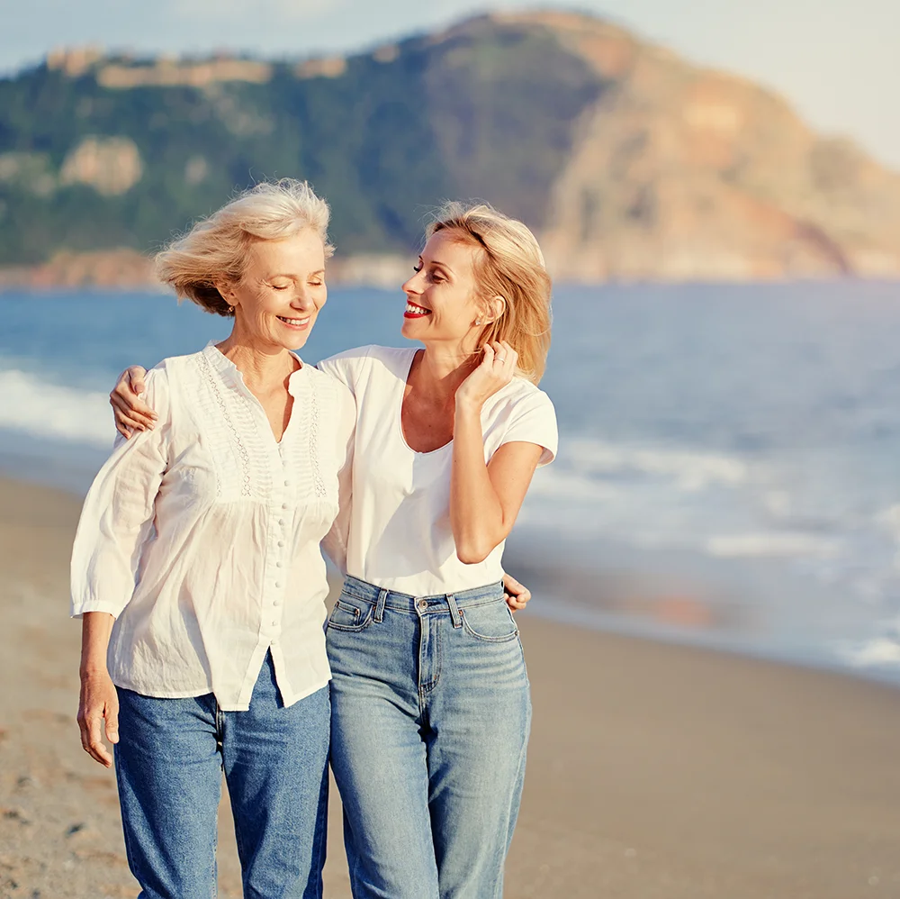 An adult daughter and her father sharing a warm moment together
